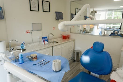 Clean and organized dental examination room with equipment and instruments ready for patient care.